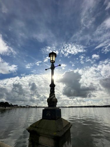 lamp post in front of a lake